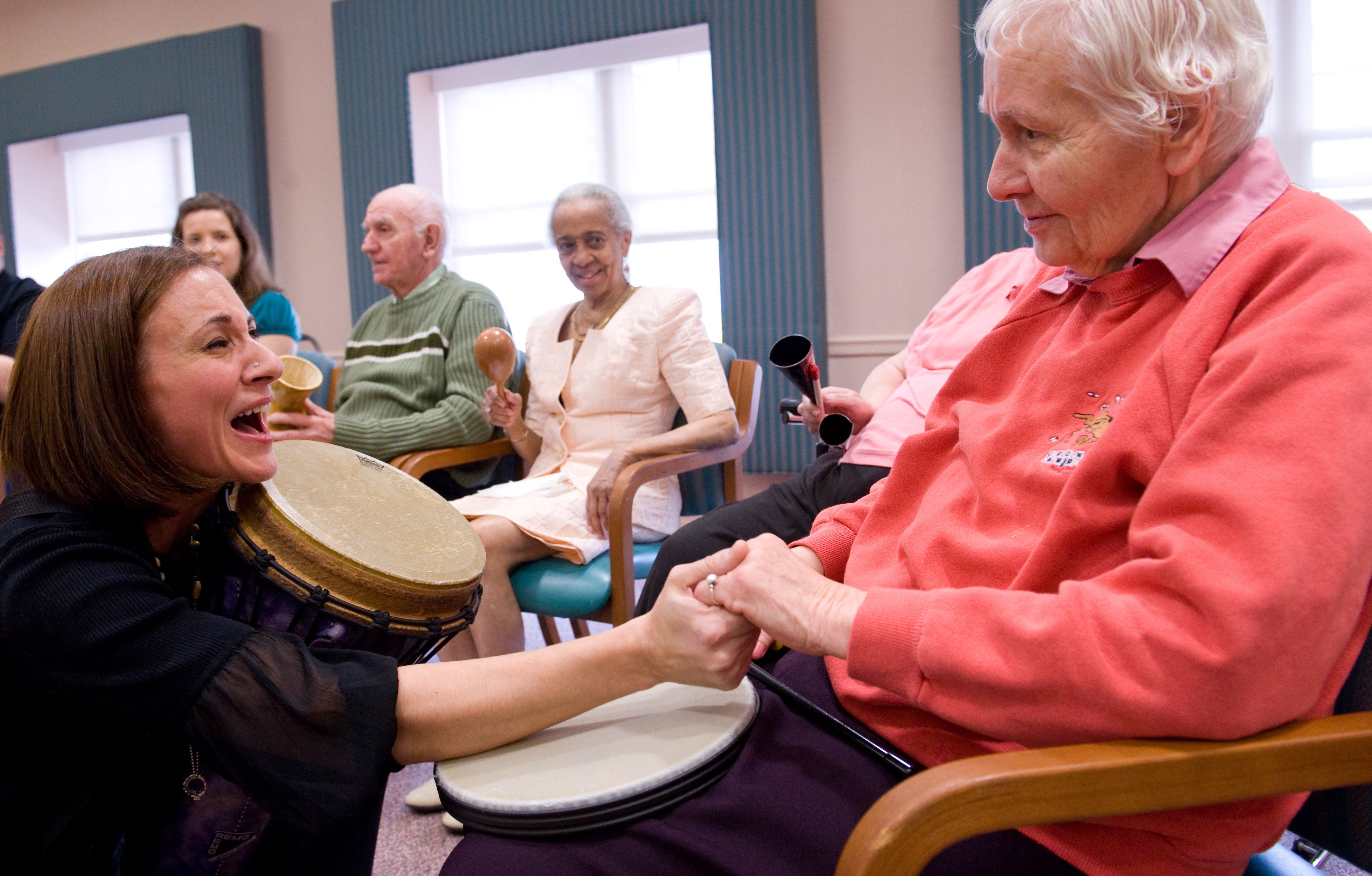 A music therapist leads a drum circle of Alzheimer’s disease patients in Maryland in October 2009. A new analysis has found that Alzheimer’s patients in rural communities are underserved