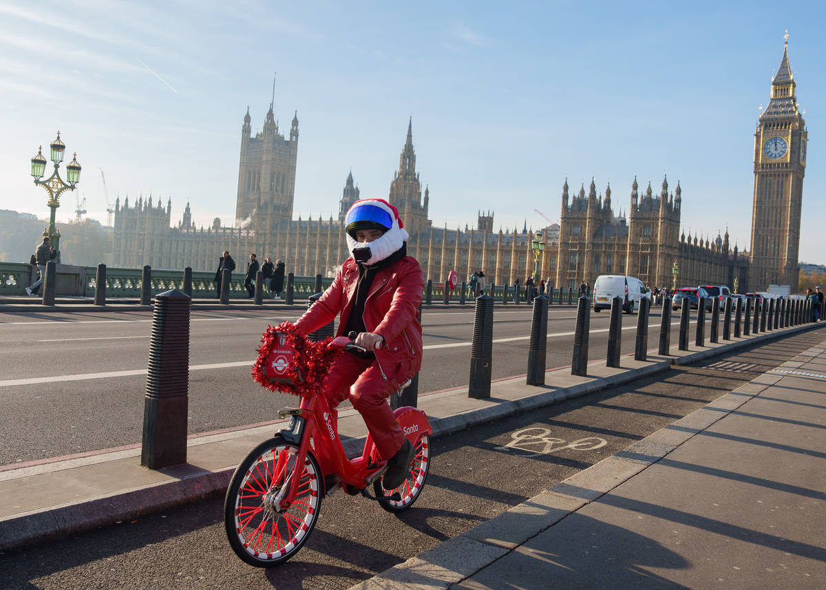 harveyridesbikes cycling across bridge near houses of parliament as London has been named the kindest city at christmas