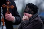 A mother cries in front of the coffin of her son Oleh Borovyk, a Ukrainian serviceman who was killed in fighting with Russian forces near Pokrovsk, during his funeral ceremony in Boiarka, Ukraine, on Wednesday, Dec. 3, 2025.  