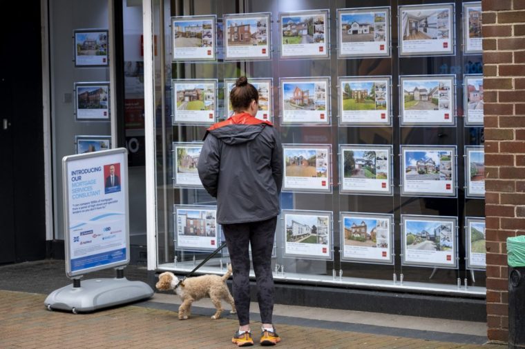 Woman looking in the window at properties advertised in the window of an estate agent on 29th May 2024 in Macclesfield, United Kingdom. Macclesfield is a market town and civil parish in the authority of Cheshire East. Housing in the UK is a very important contributing factor and measure in the economy as house prices and the property market continues to rise, pricing many people of lower incomes out of owning their own homes. (photo by Mike Kemp/In Pictures via Getty Images)
