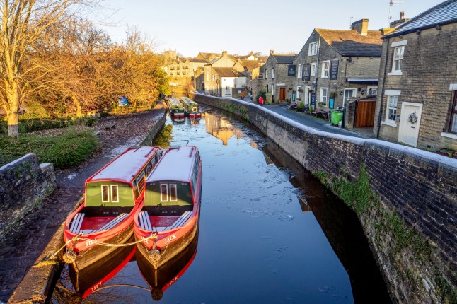 Canal narrowboats ready for guided tours on the Leeds Liverpool canal in Skipton, North Yorkshire.