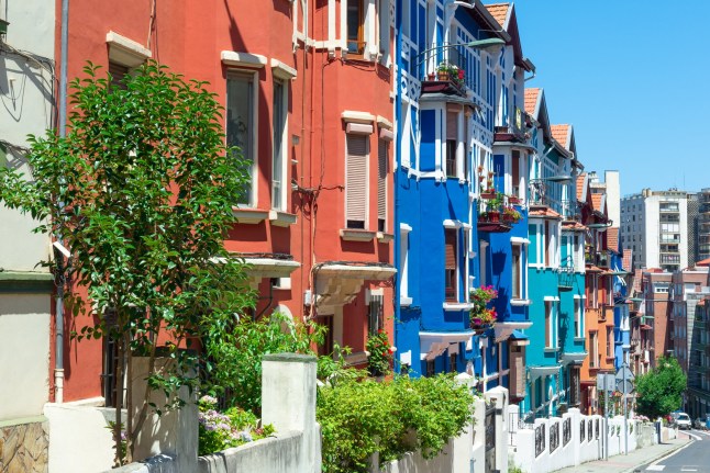 A bright view of multi-coloured houses in the Irala neighborhood of Bilbao, Spain.