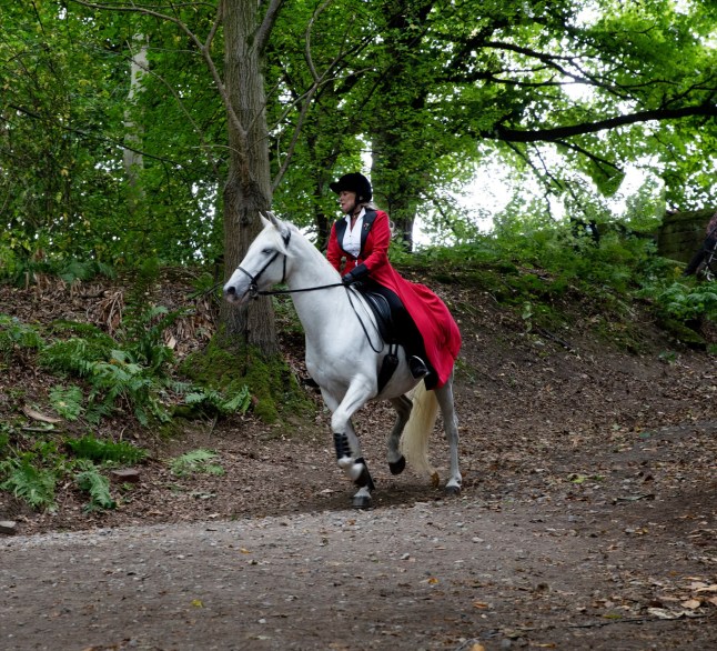 Kim riding Ice the Horse through the woods in Emmerdale
