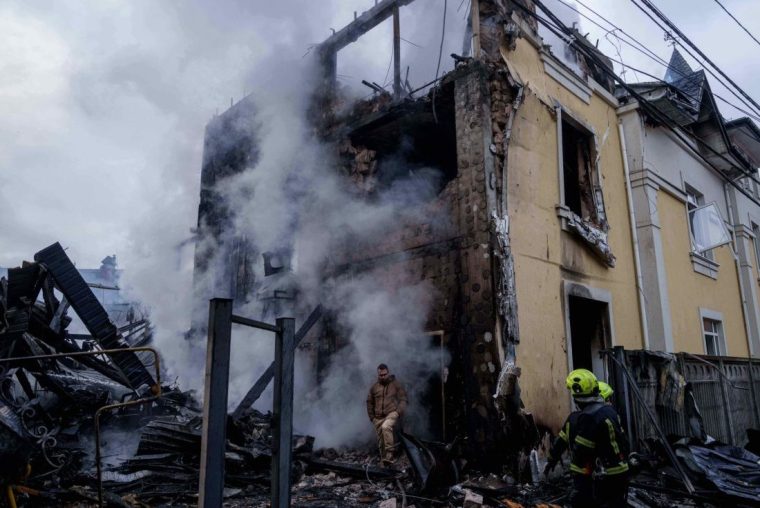 A man walks from a house destroyed after a Russian strike on Kyiv, Ukraine, on Saturday, Dec. 27, 2025. (AP Photo/Evgeniy Maloletka)