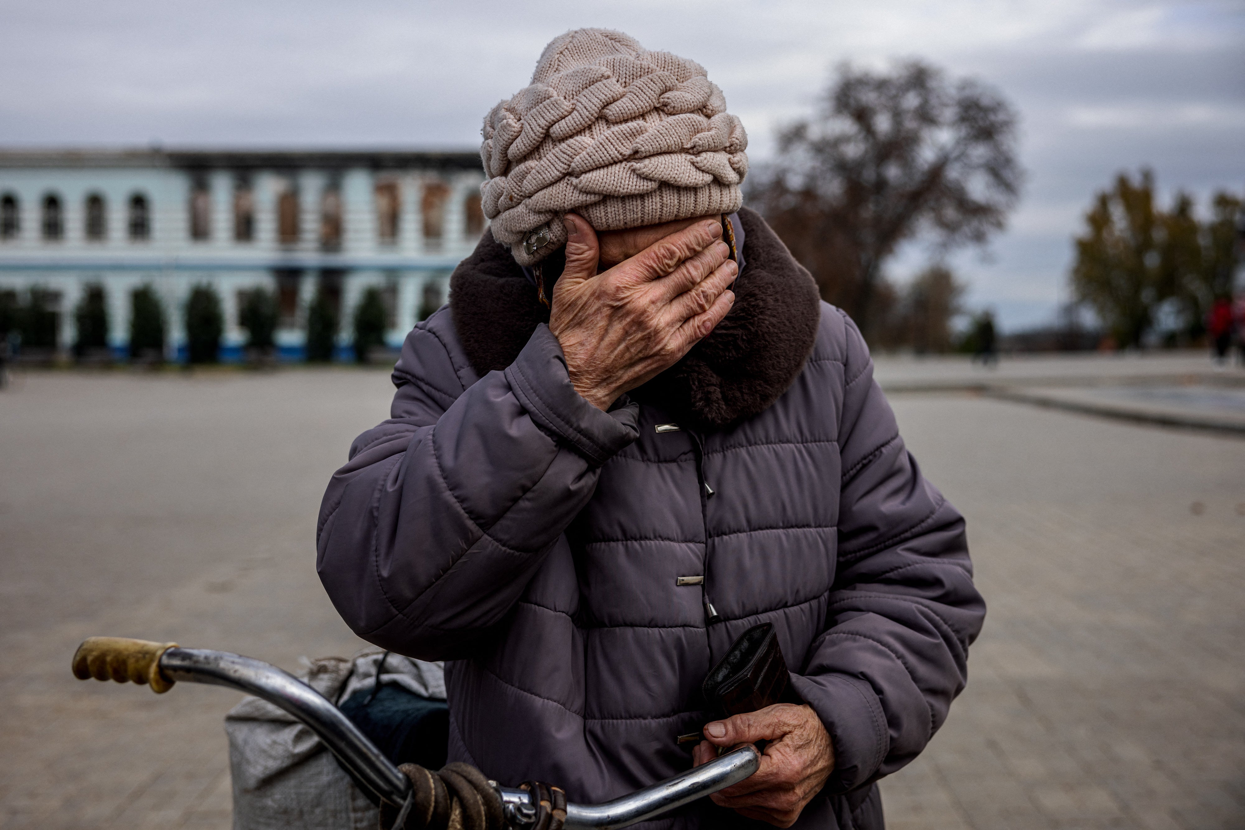 An elderly woman waits to get a free SIM card from a mobile operator in the town of Izyum, in the Kharkiv region, in November 2022