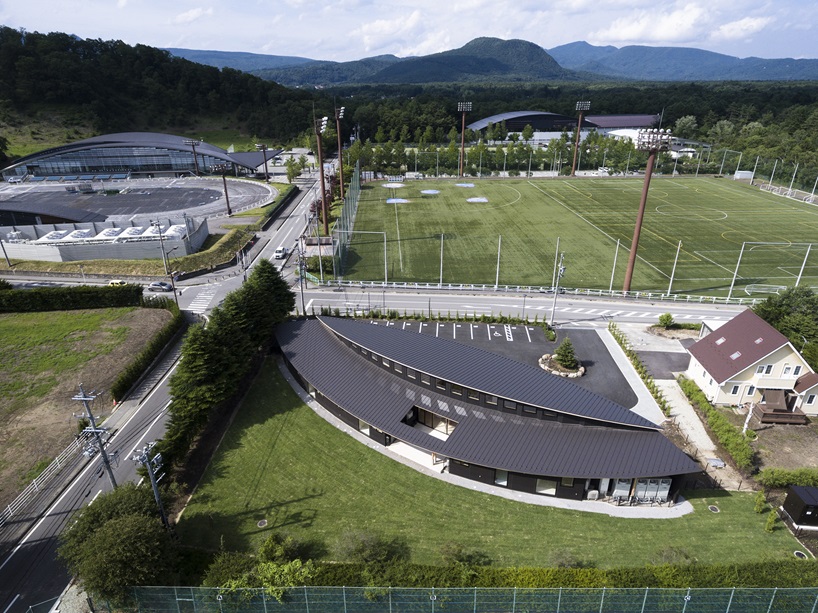 twin leaf-shaped roofs unfold atop nursery school by NIKKEN SEKKEI in japan