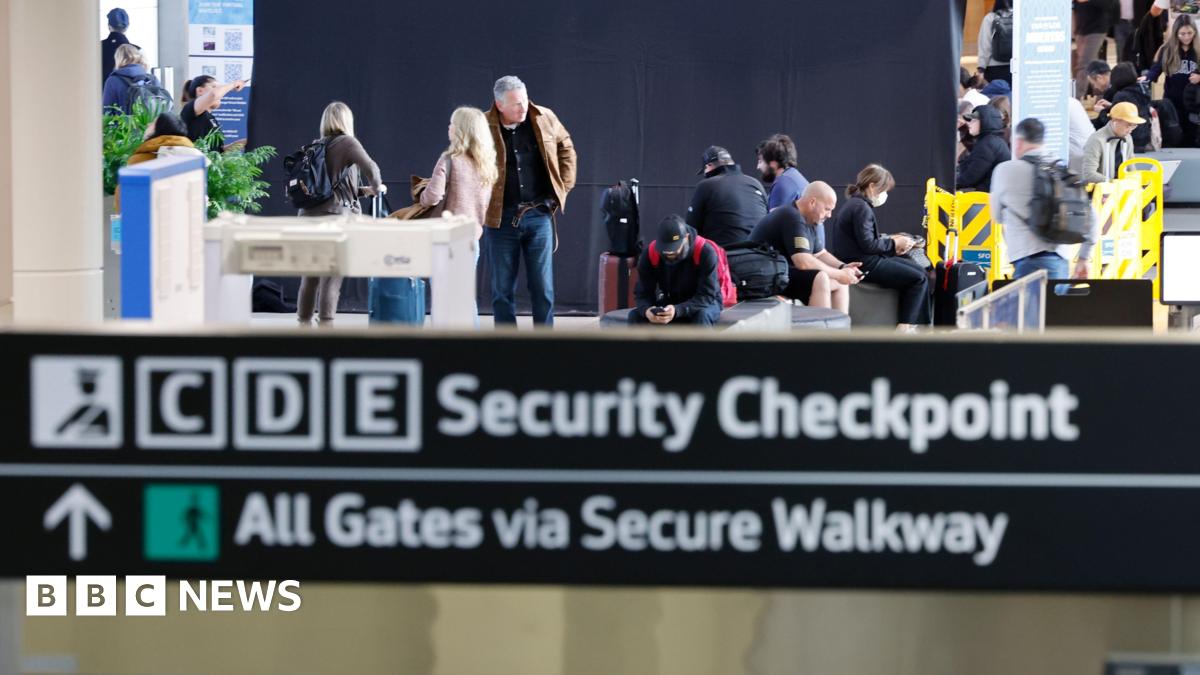 Passengers pass through the Transportation Security Administration (TSA) security checkpoint at San Francisco International Airport