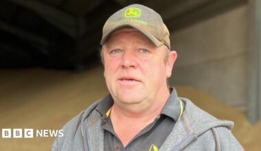 Dan Willis is wearing a black T-shirt, grey hoodie and a black cap that says John Deere on it.