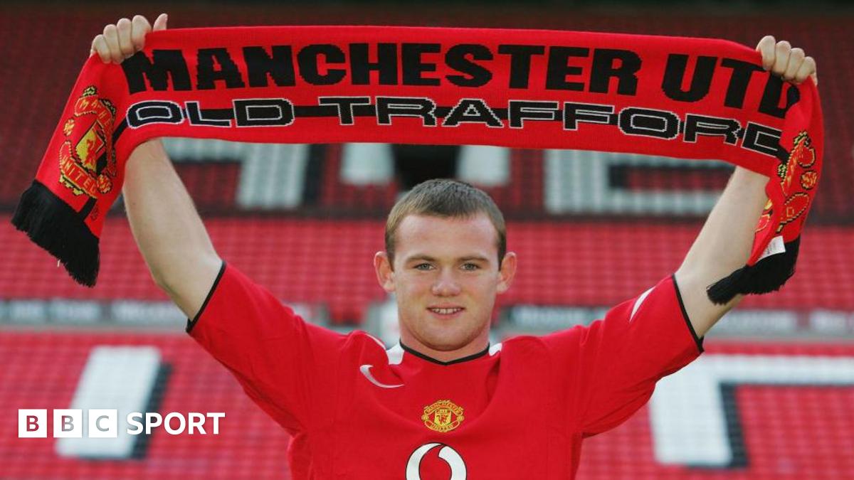 Wayne Rooney holds up a Manchester United scarf after joining the club