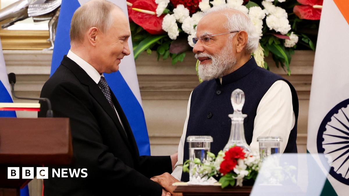 Russian President Vladimir Putin and India's Prime Minister Narendra Modi shake hands as they attend a presentation of a joint statement after their delegation level talks at Hyderabad House in New Delhi/