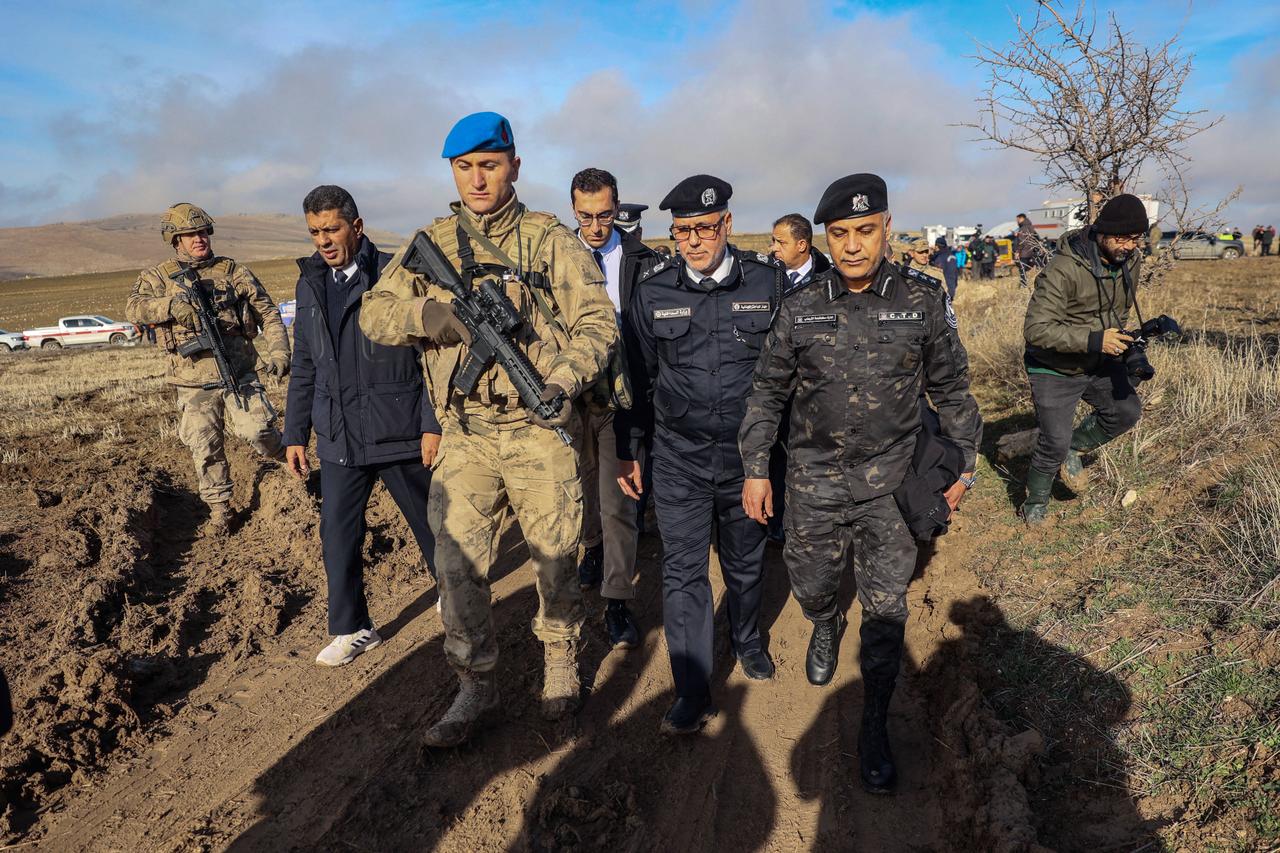 Libyan military delegation members arrive at the wreckage site following the crash of a Libya-bound business jet at Haymana district in Ankara on December 24, 2025. (AFP Photo)