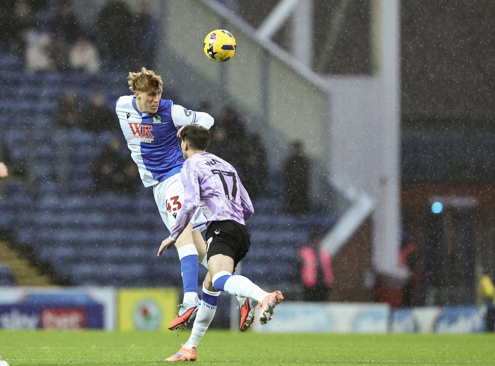Blackburn Rovers' George Pratt heads the ball under pressure from Sheffield Wednesday's Charlie McNeill