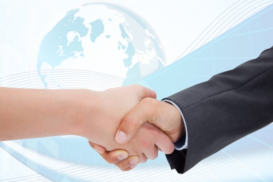 Illustration of two people shaking hands in a business agreement, with a stylized globe in the background.