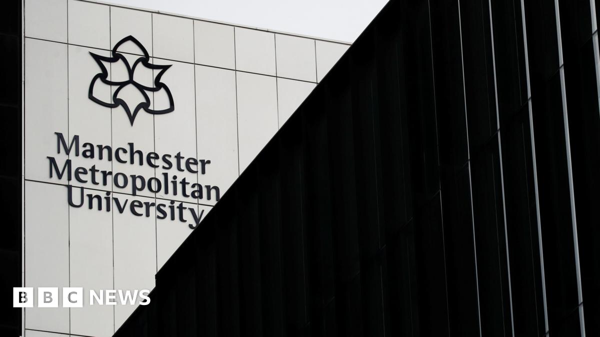 Exterior shot of a metal-covered building with the Manchester Metropolitan University name and logo on it.