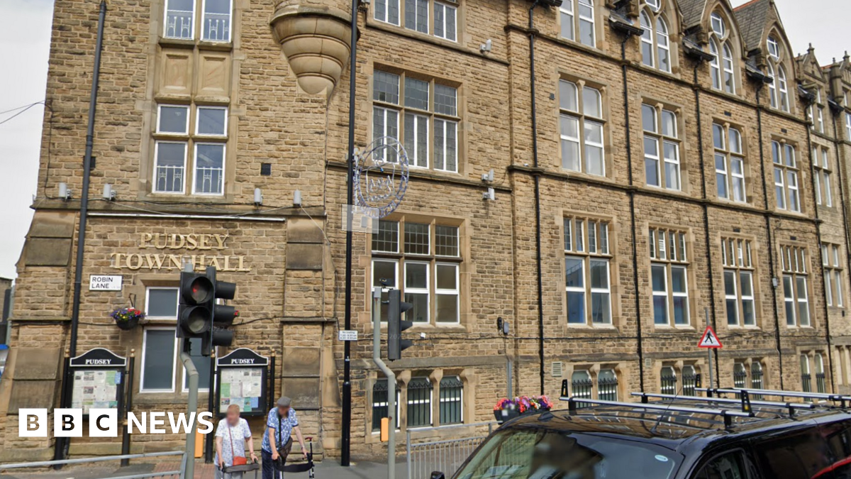 A large Victorian building with the words Pudsey Town Hall written above one of several windows in gold lettering