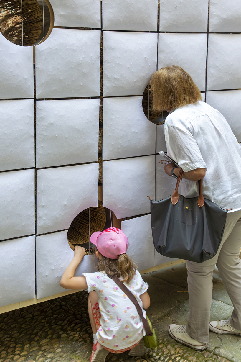 mirroring pillowed walls filled with reed grass compose sensory installation in montpellier