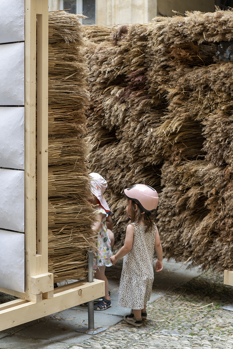 mirroring pillowed walls filled with reed grass compose sensory installation in montpellier