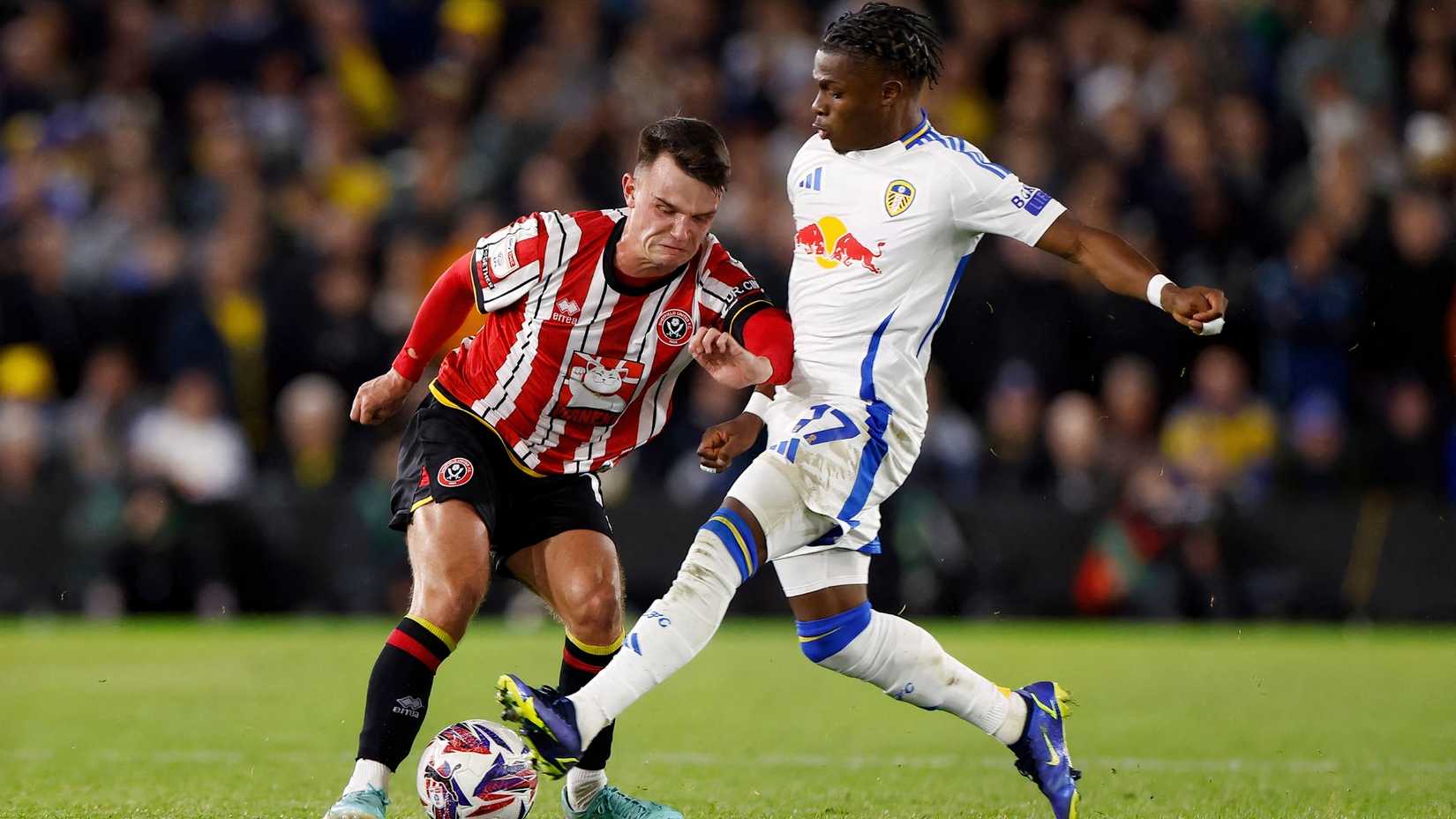 Sheffield United's Jamie Shackleton in action with Leeds United's Largie Ramazani