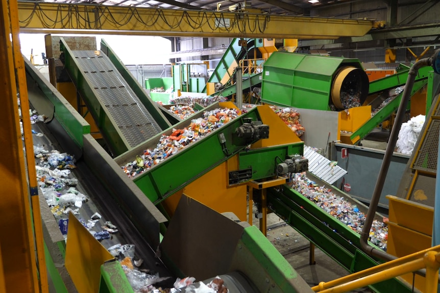 A wide shot of a soft plastics recycling facility, showing conveyer belts.