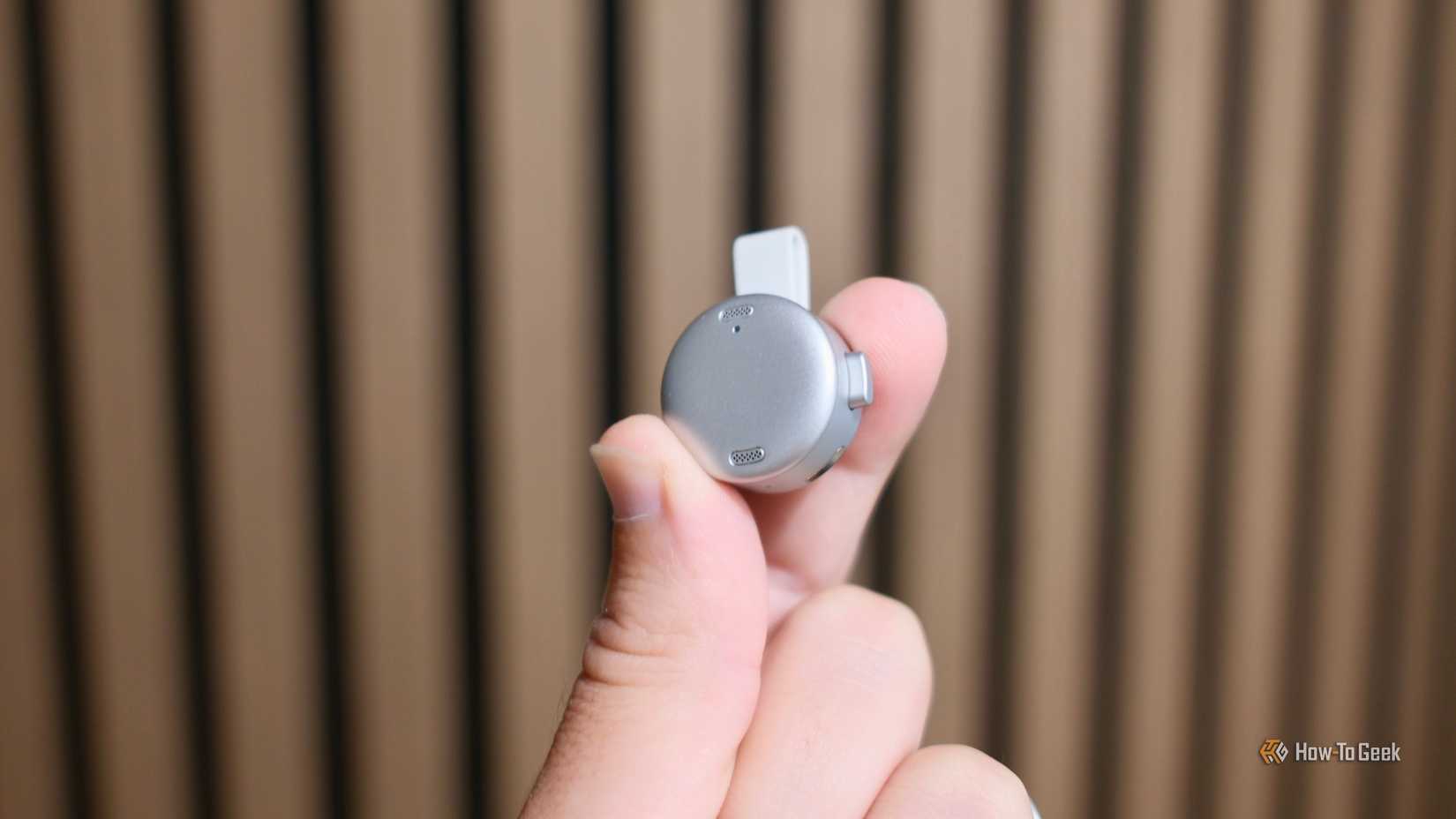 The microphone part of the Anker Soundcore Work being held in hand.