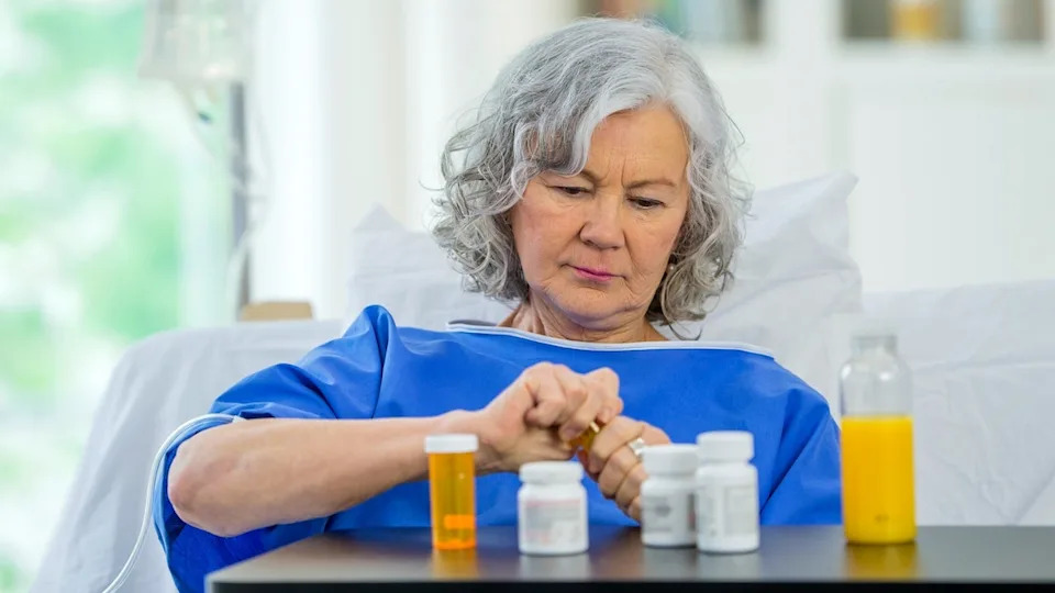 Woman taking medications in hospital
