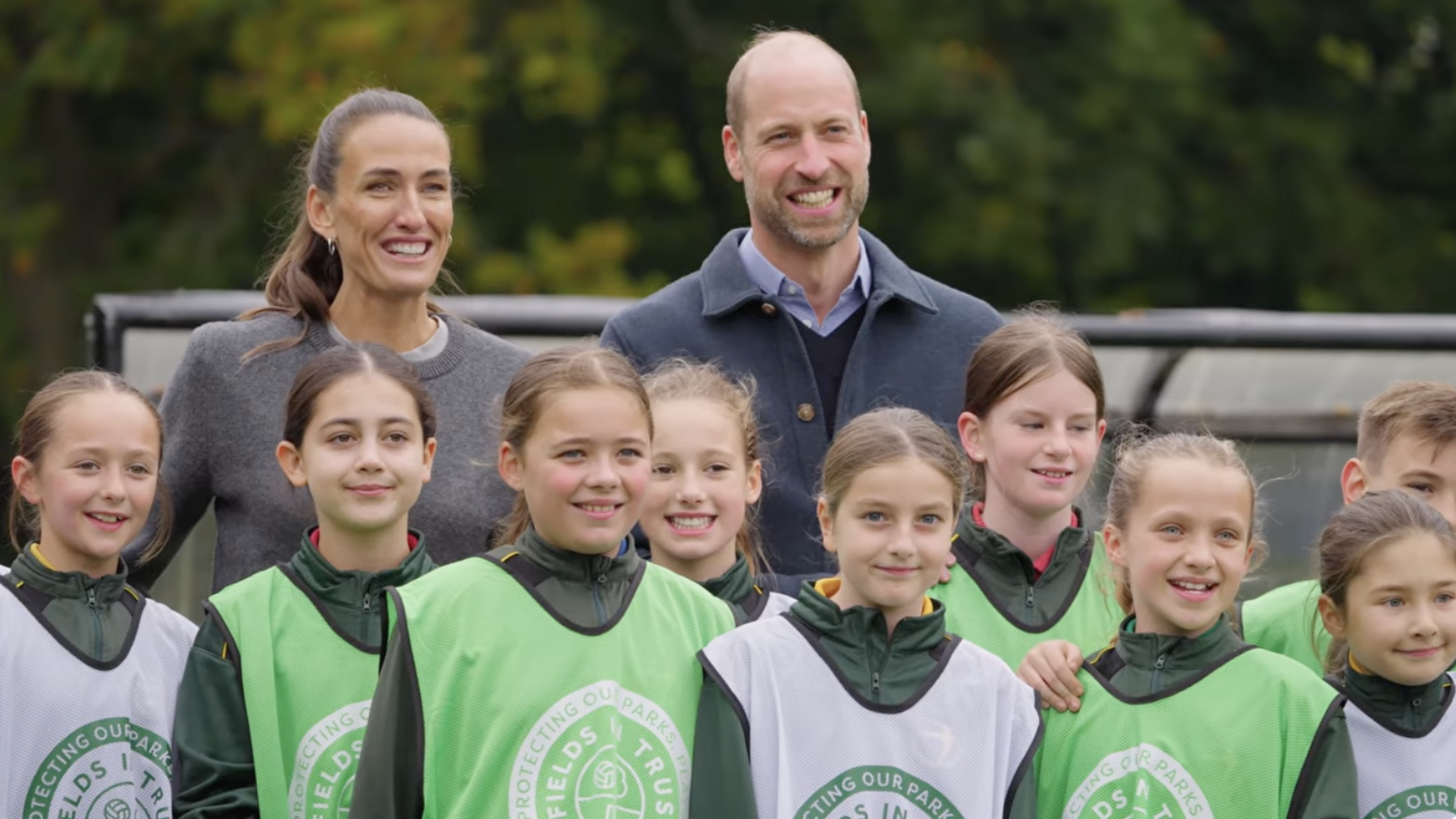 Prince William and Jill Scott posing with young soccer players