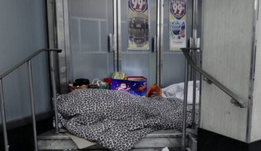 Two homeless people sleeping on the streets in Woolwich, London.