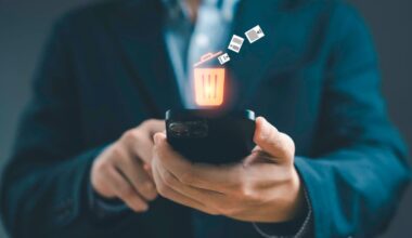 A person holds out a phone with an illustration of a filling trash can above it.