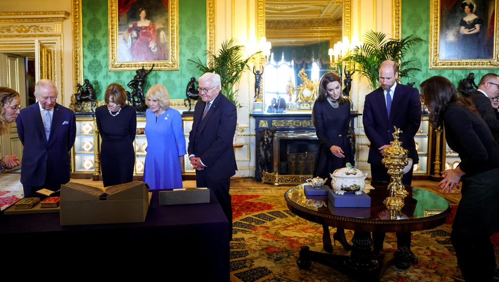 State Visit By The President Of The Federal Republic of Germany - Day 1 windsor, england december 3: (l r) king charles iii, elke buedenbender, queen camilla, german president frank walter steinmeier, catherine, princess of wales and prince william, prince of wales view items on display relating to germany during a visit to the royal collection exhibition in the green drawing room during german president frank walter steinmeiers state visit to britain on december 3, 2025 in windsor, england. the president of the federal republic of germany, accompanied by ms. elke büdenbender, are paying a state visit to the united kingdom as the guests of their majesties the king and queen. the visit is the first from germany in 27 years and will be marked with ceremonial visits, an address to the uk parliament and a banquet. (photo by hannah mckay pool/getty images)