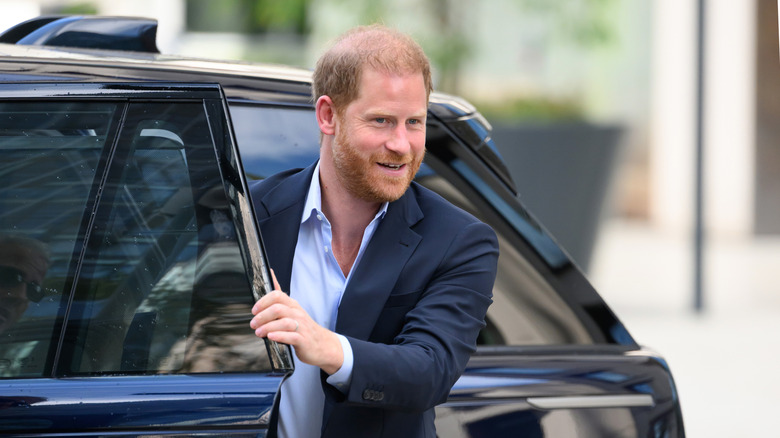 Prince Harry getting out of a car