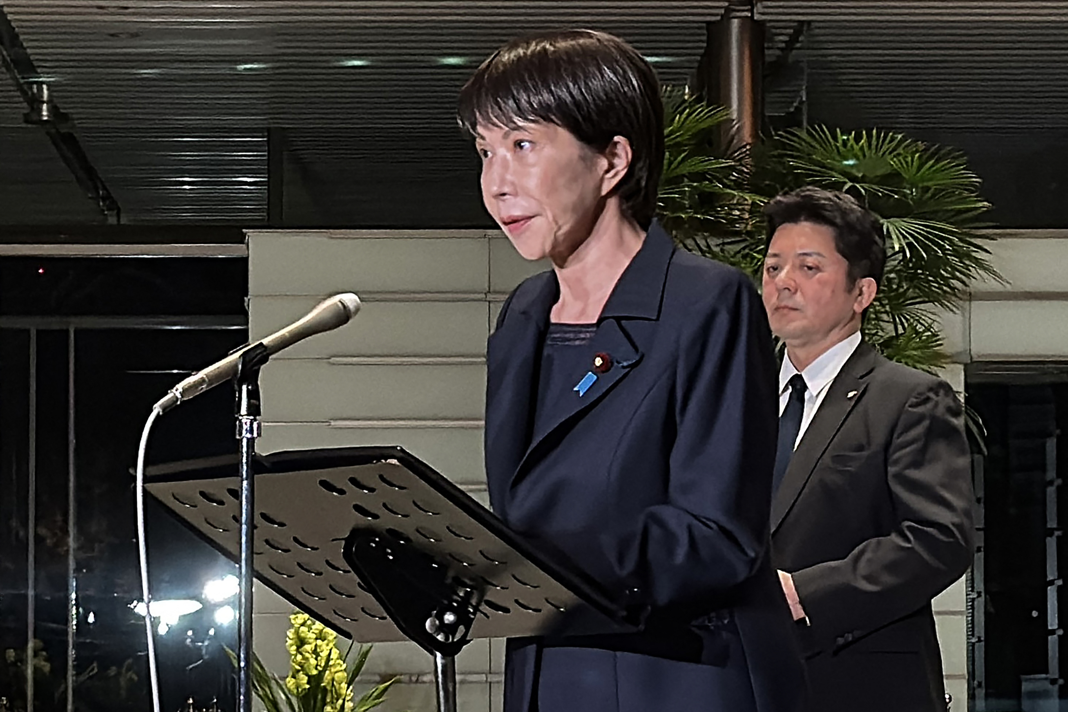 A photo of the Prime Minister of Japan, Sanae Takaichi, addressing the media following the country's magnitude 7.6 earthquake on Monday.