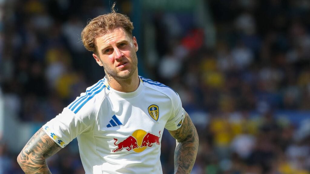 Joe Rodon puts his hands on his hips in a Leeds shirt