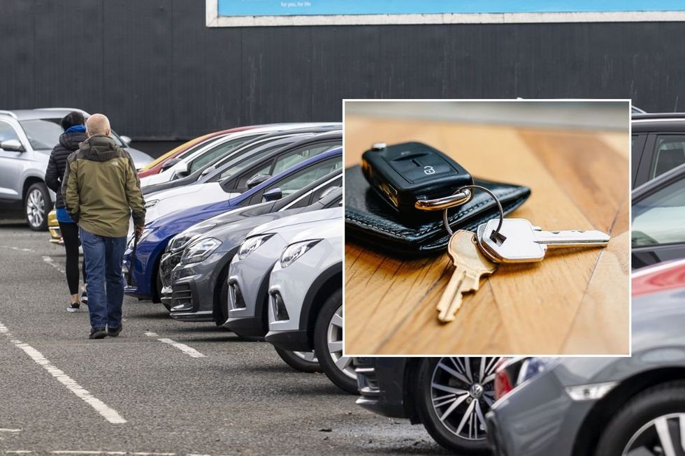 People looking at a car dealership and a set of car keys