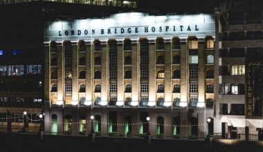 London Bridge Hospital illuminated by lights at night.