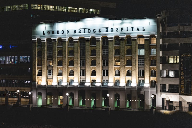 London Bridge Hospital illuminated by lights at night.