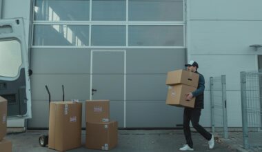 a delivery driver carrying boxes to a van