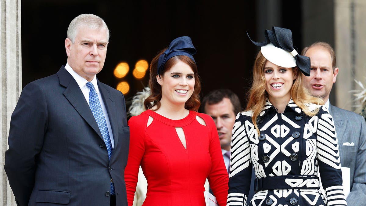 Prince Andrew looking stern in a dark suit and blue tie standing next to his daughters and brother Prince Edward