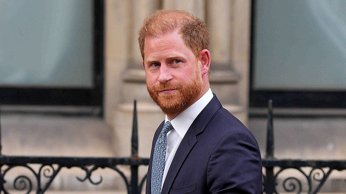 Prince Harry wearing a blue suit as he exits court in April 2025