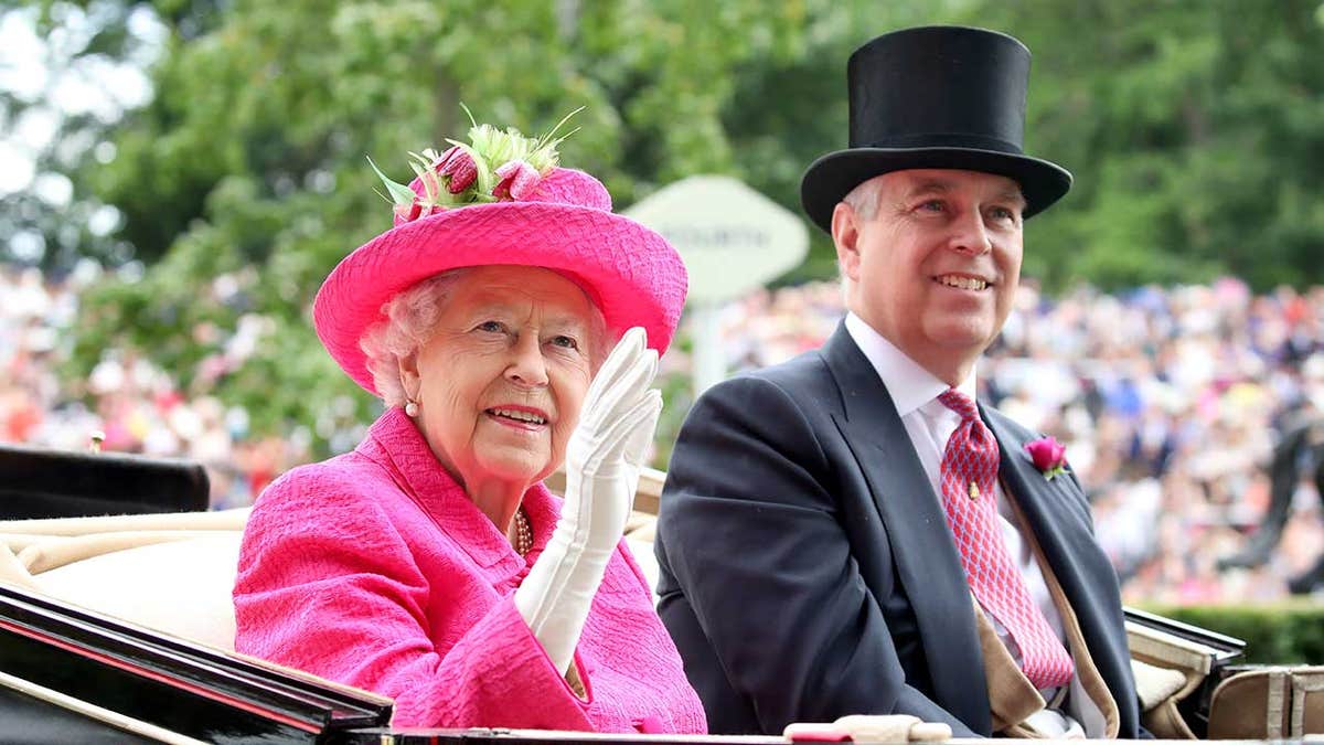 Queen Elizabeth smiling alongside Prince Andrew in a royal carriage outdoors.