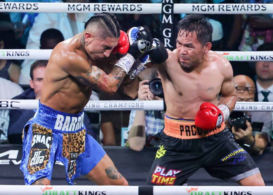 Manny Pacquiao (R) throws a right at Mario Barrios in the seventh round of their WBC welterweight title fight at MGM Grand Garden Arena on July 19, 2025 in Las Vegas, Nevada. The fight was declared a majority draw and Barrios retained his title.