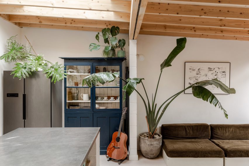 Guitar stands in front of a door in A Simple Addition by OEB Architects