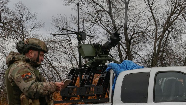 A service member of the 125th Separate Heavy Mechanized Brigade with a Kalashnikov tank machine gun. Pic: Reuters