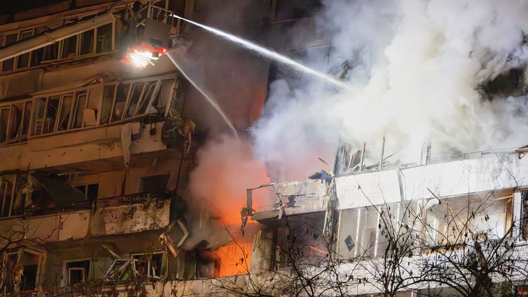 Firefighters put out a fire after a drone hit a multi-storey residential building during Russia's night drone attack in Kyiv. Pic: AP