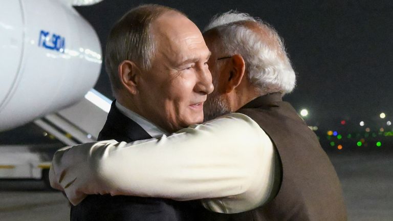 Vladimir Putin (L) and Narendra Modi embrace at Palam Air Base in New Delhi, India. Pic: Kremlin Pool/AP