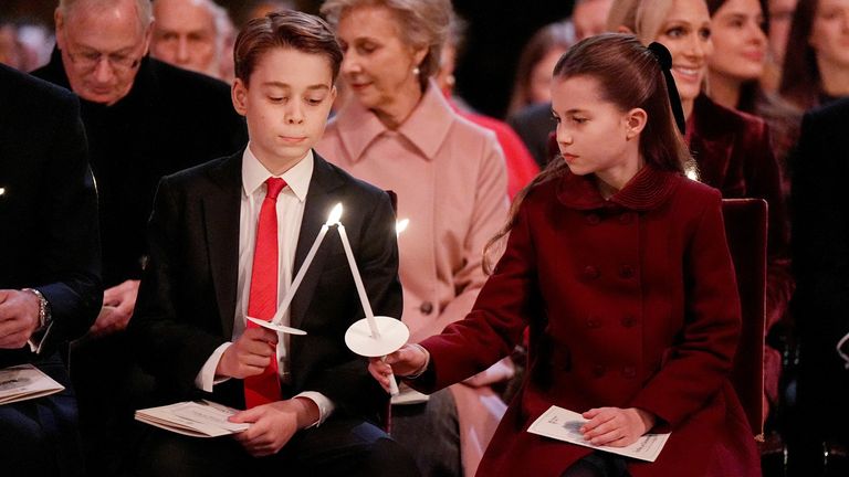 Prince George and Princess Charlotte lighting candles. Pic: Reuters