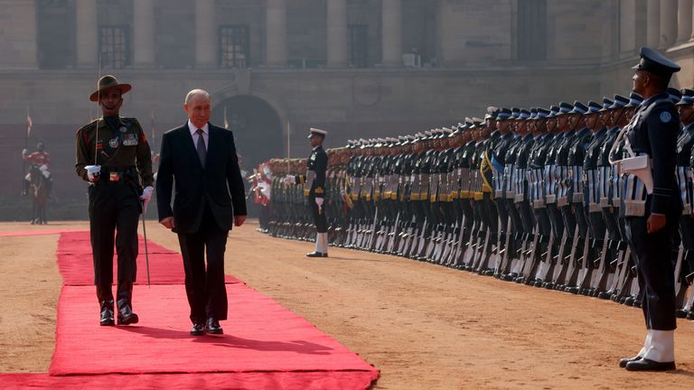The Russian leader walks past a guard of honour during a ceremonial reception ahead of trade talks in New Delhi. Pic: Reuters