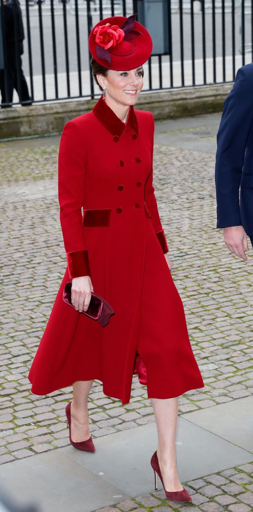 a person in a striking red outfit with a matching hat and accessories