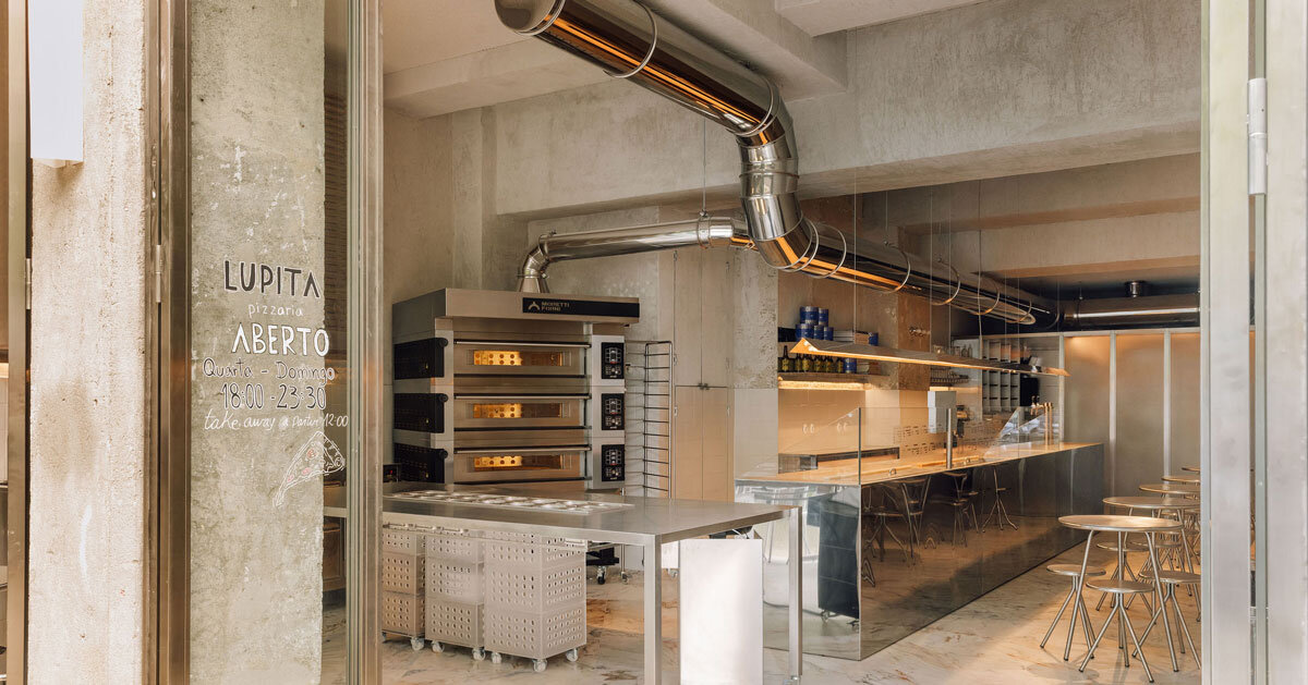 reflective steel interiors bring lisbon’s street activity into pizza restaurant
