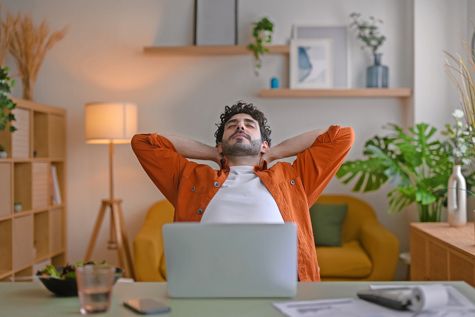 Young man resting in a chair while teleworking.