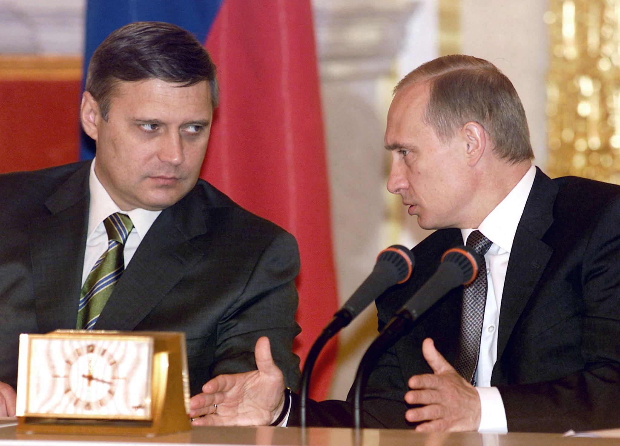 Russian President Vladimir Putin gestures while speaking with Prime Minister Mikhail Kasyanov.